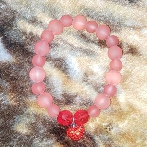 Red bracelet with heart charm
